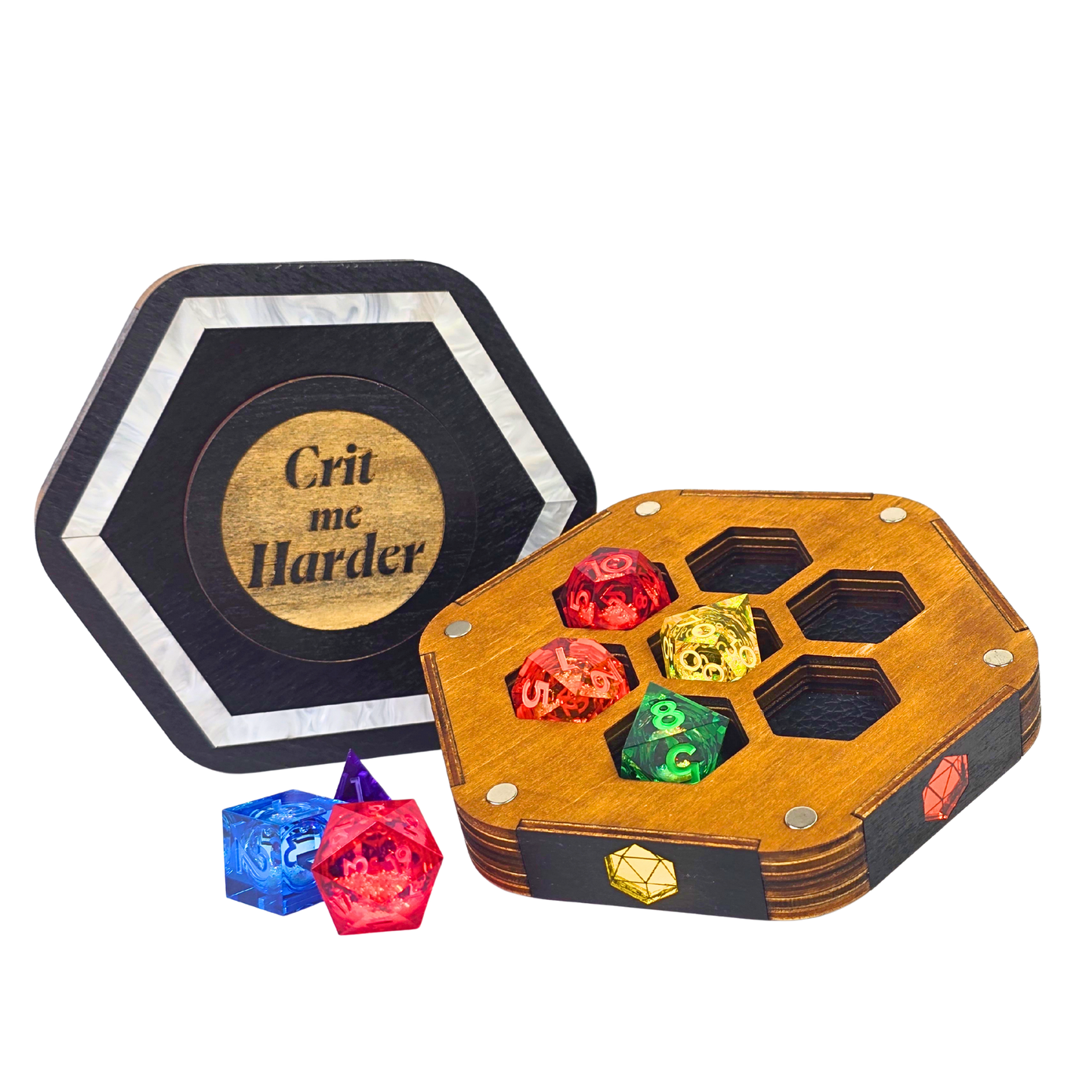 Jeweled Agenda Dice Vault lid engraved Crit me Harder with a pearlized ivory border, beside the open base holding 7 polyhedral dice in honeycomb pockets